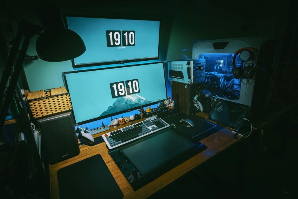 A tidy gaming desk with a monitor arm, soft lighting, and cables hidden below the desktop