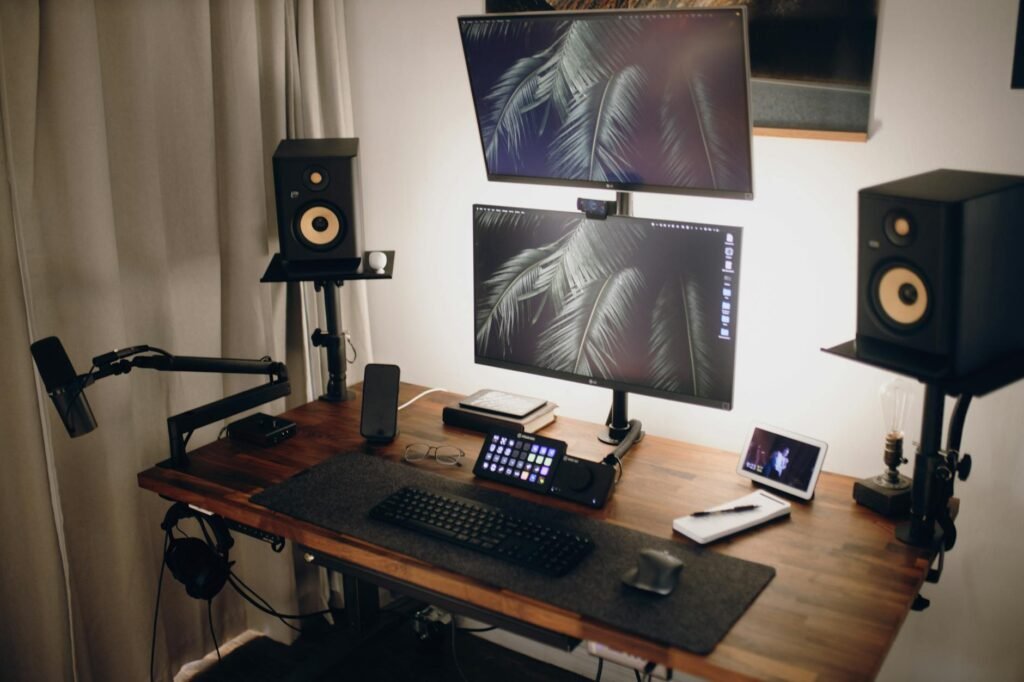 A tidy dual-monitor setup on a compact desk with controlled cables and a clear work surface