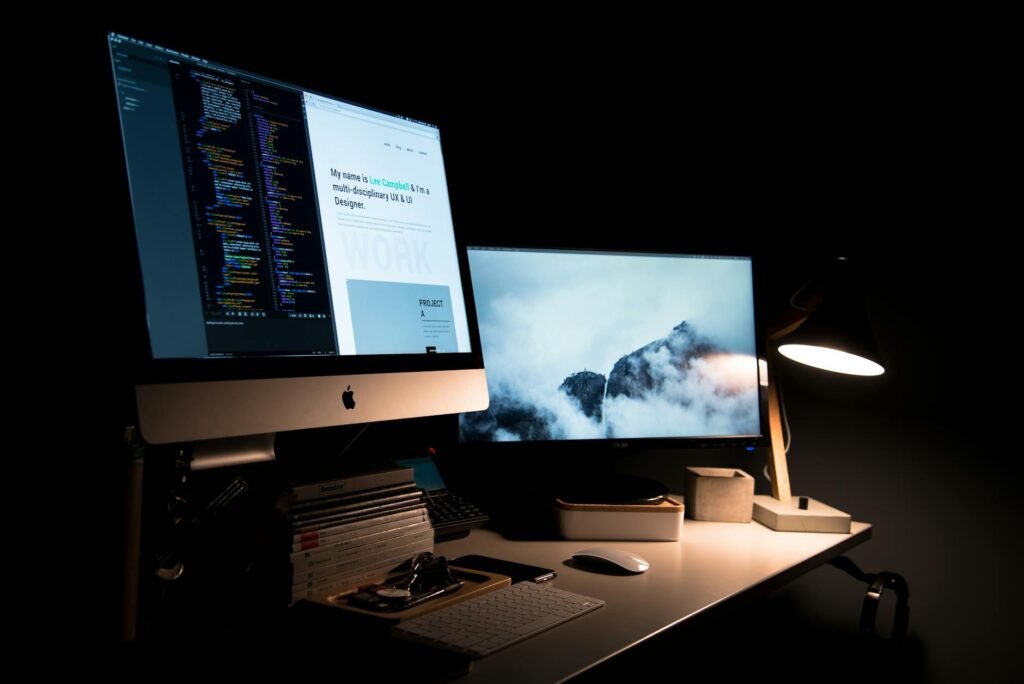 A desk lamp and computer monitor arranged to reduce screen glare