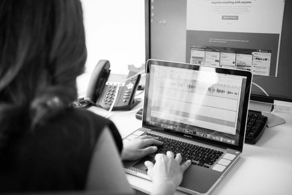 A clean desk with a laptop connected to an external monitor and a keyboard and mouse