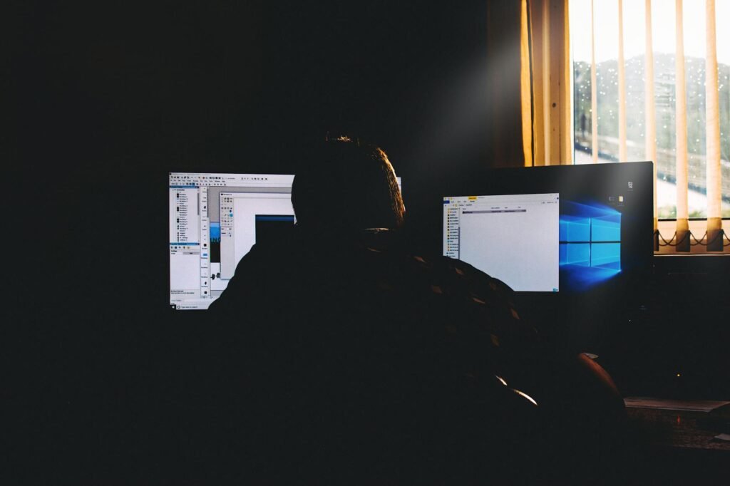Small desk by a window with lighting positioned away from the computer screen