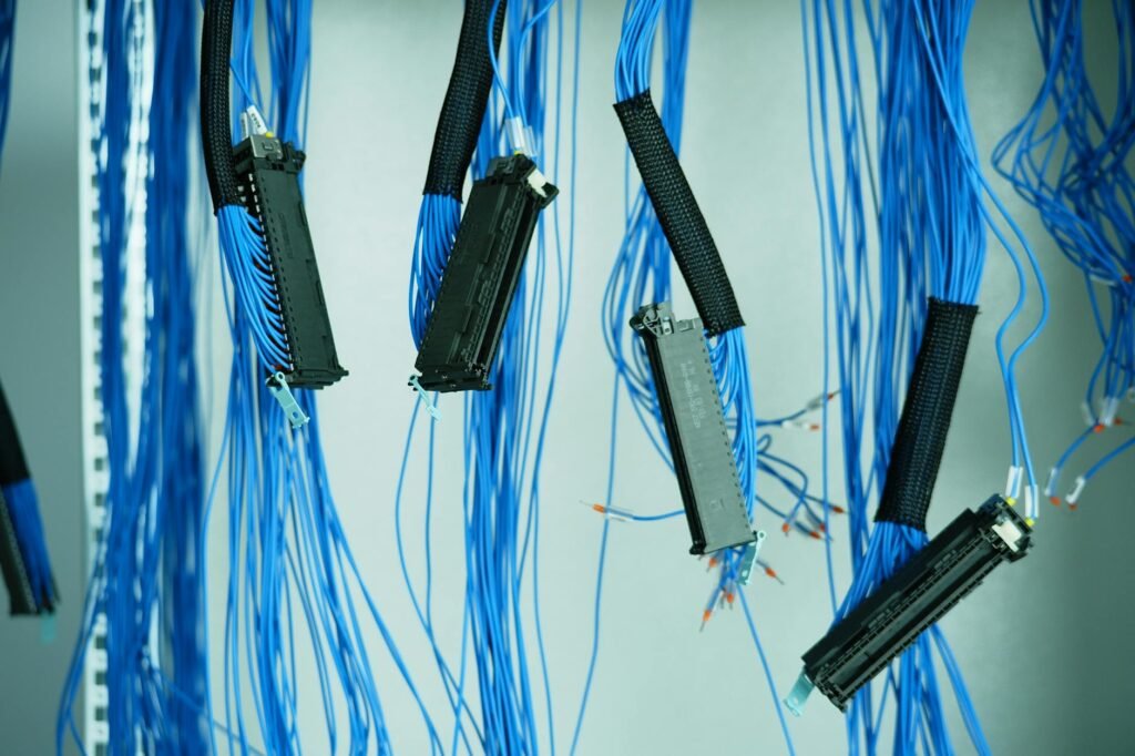 Reusable cable ties and clips organizing a few cables beneath a desk.
