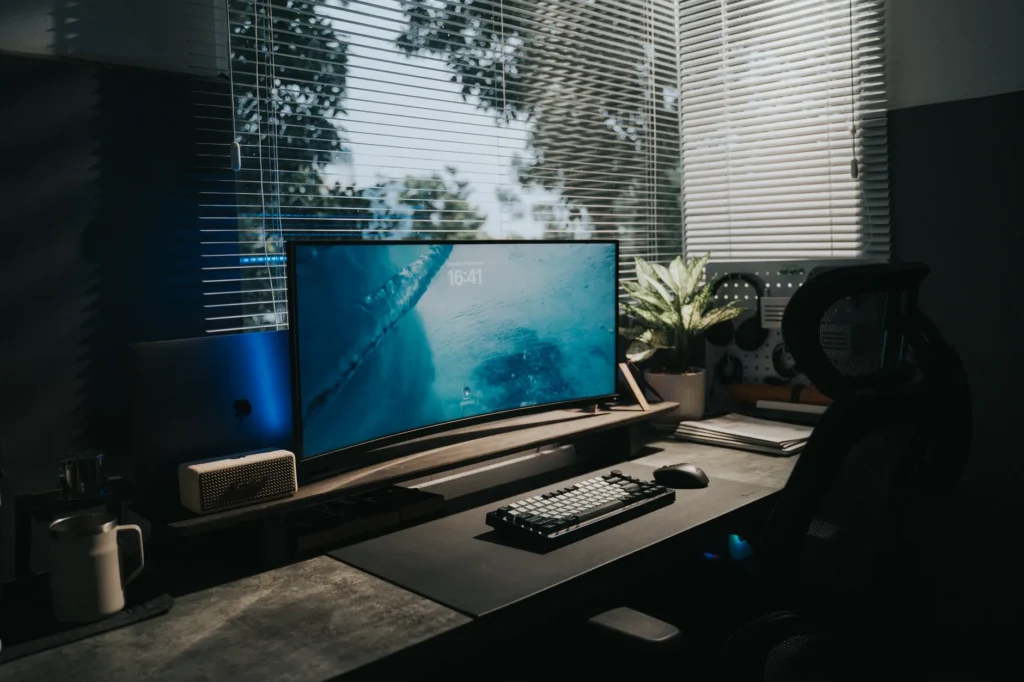 Desk setup with footrest, raised monitor, and clear space under the desk