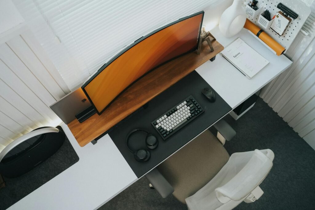 A desk setup with the monitor centered at a comfortable height and a supportive chair