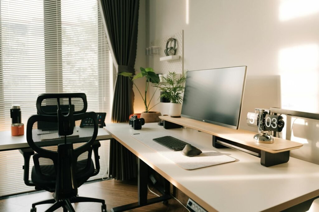 A home office desk with the monitor centered directly in front of the keyboard and chair