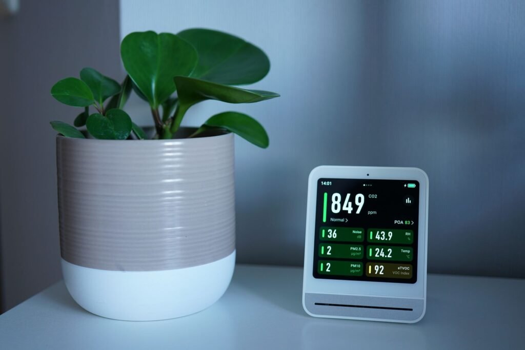 A small air cleaner in a home office near a desk setup.