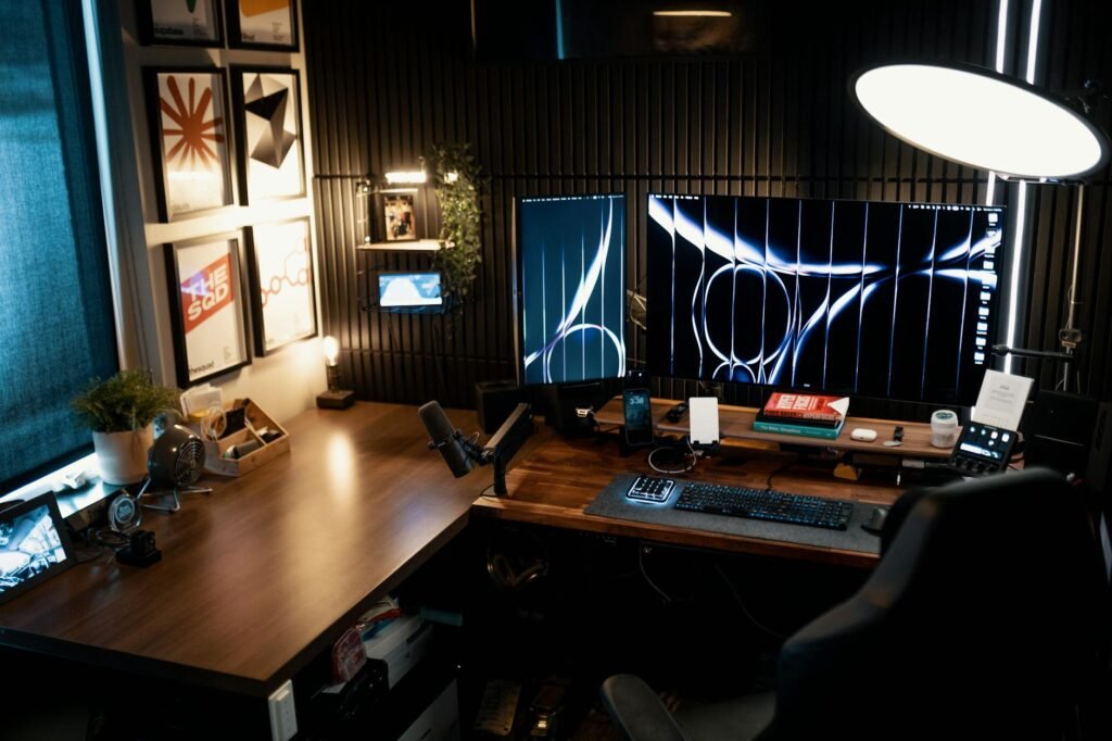 A person adjusting the position of two monitors at a desk