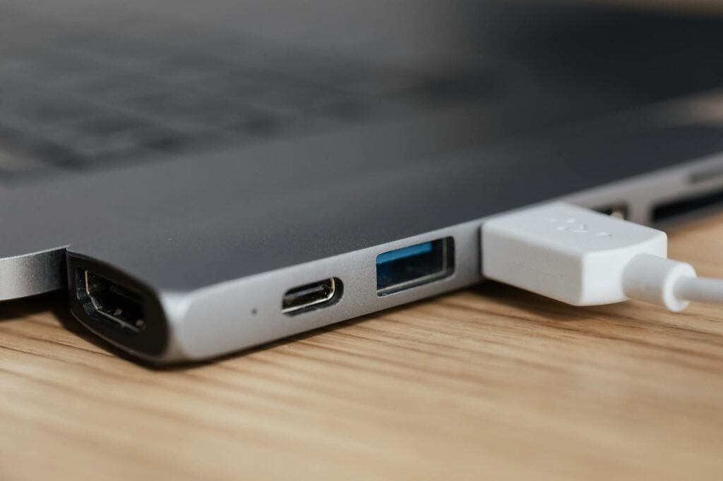 Someone testing USB ports and cables on a new computer during setup.