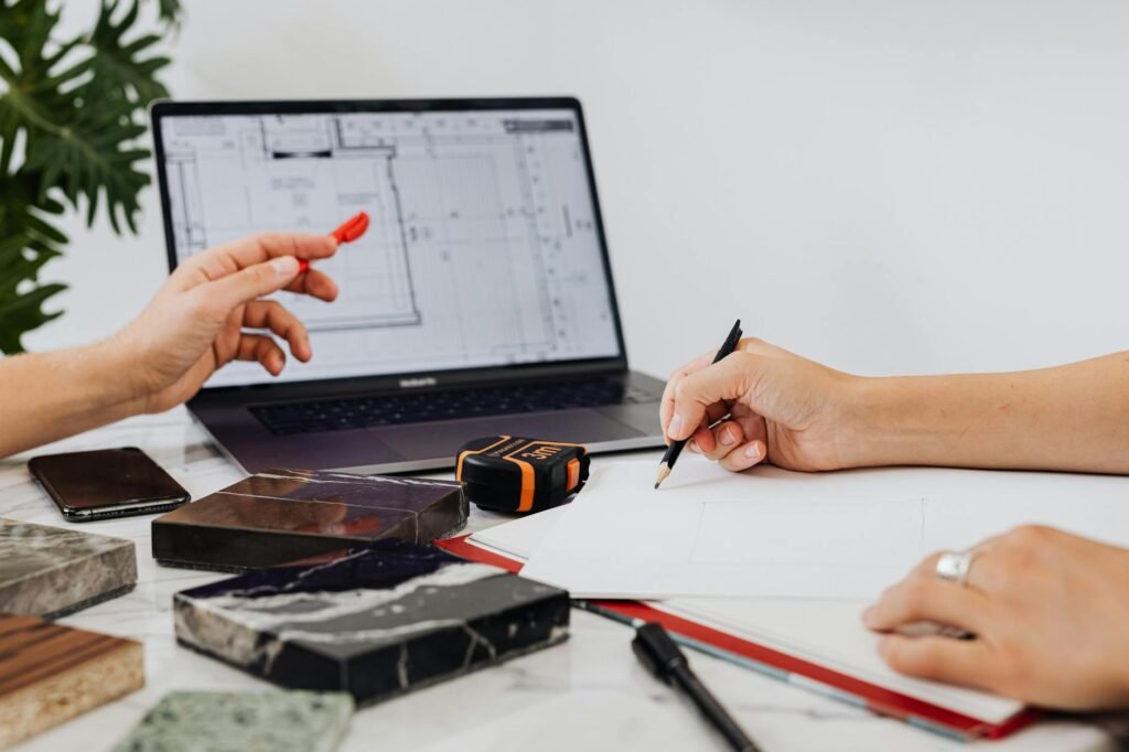 A tape measure being used to check desk depth before setting up monitors