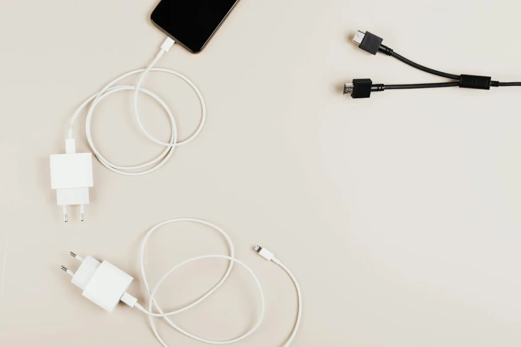 Cable management supplies including reusable ties, short cables, and adhesive anchors arranged on a desk.