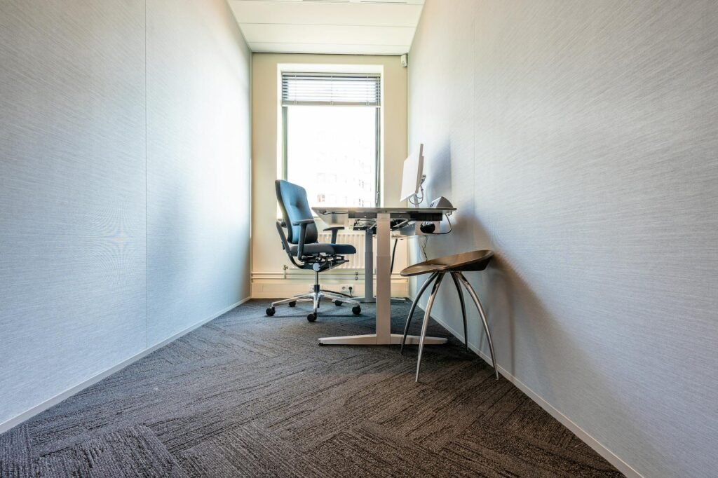 Side view of a desk setup with open leg room and a chair tucked in properly
