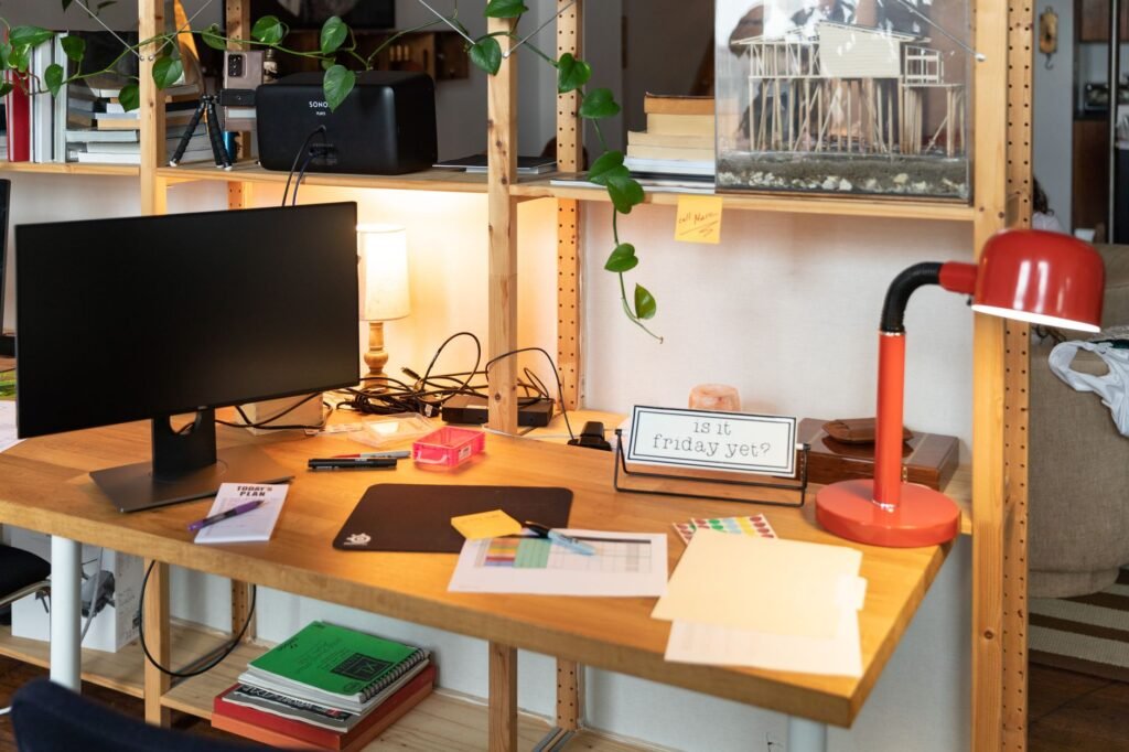 A tidy home office desk with an under-desk cable tray and neatly routed cables.