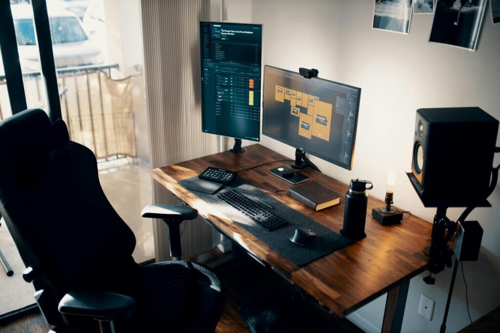 A compact desk using one main monitor and one portrait secondary screen to save space
