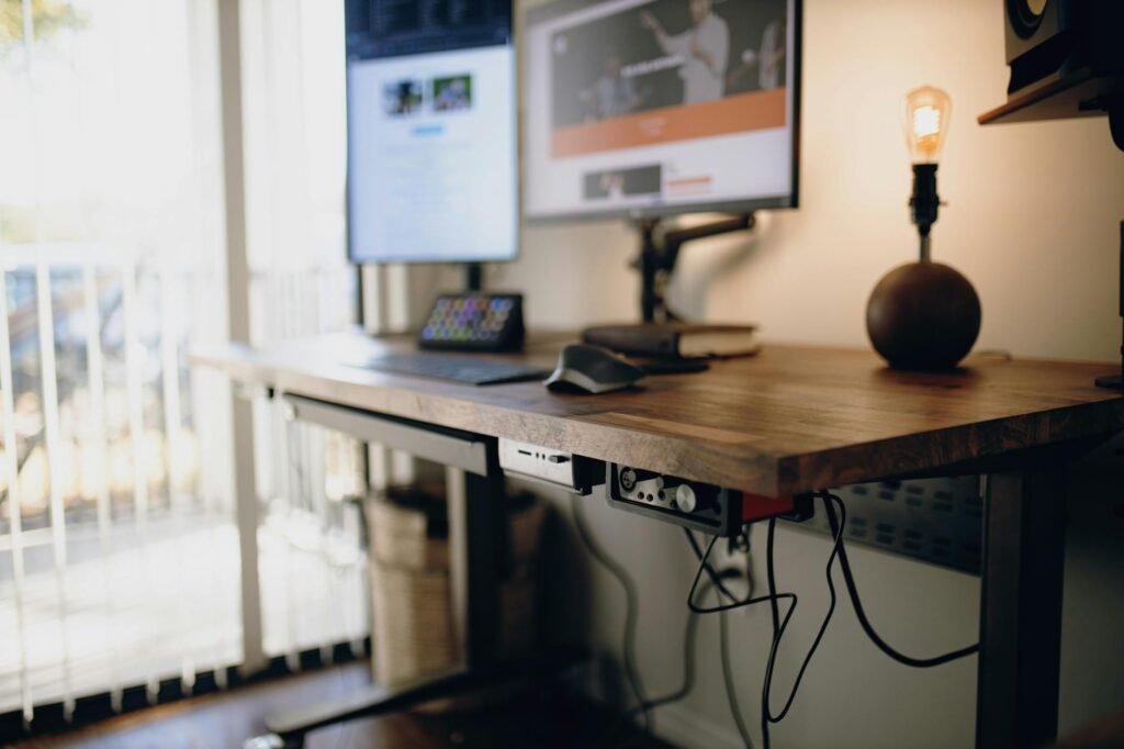 A tidy desk setup with cables routed neatly behind a monitor arm and into an under-desk tray.