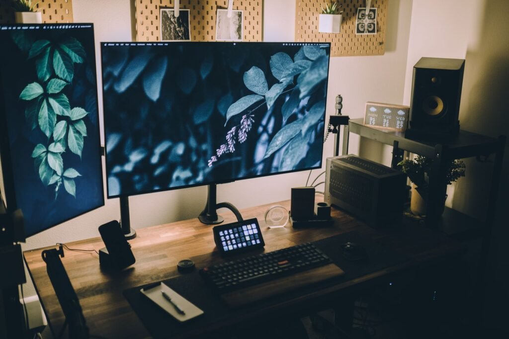 A tidy desk with two monitors arranged in a practical ergonomic layout