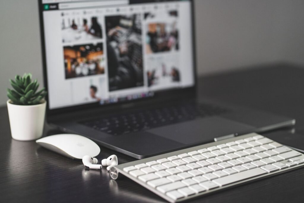 A laptop raised on a stand with an external keyboard and mouse below it
