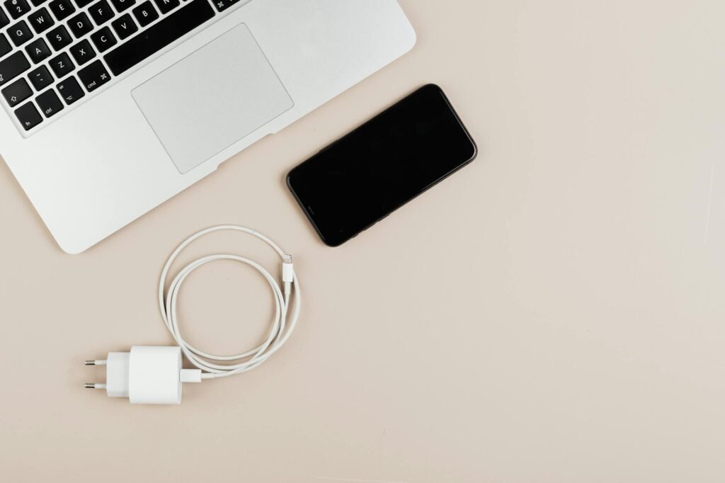 A laptop plugged into power on a simple home office desk